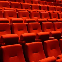 Czerwone fotele kinowe, idealne do oglądania filmów. Które miejsca w teatrze są najlepsze? Te z najlepszym widokiem i dźwiękiem!