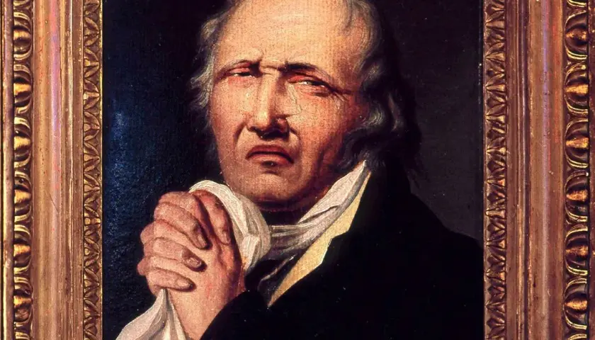 Portret mężczyzny z chusteczką w dłoniach, z wyrazem cierpienia na twarzy. Obraz przedstawia, kim był Wojciech Bogusławski, aktor i dramaturg.